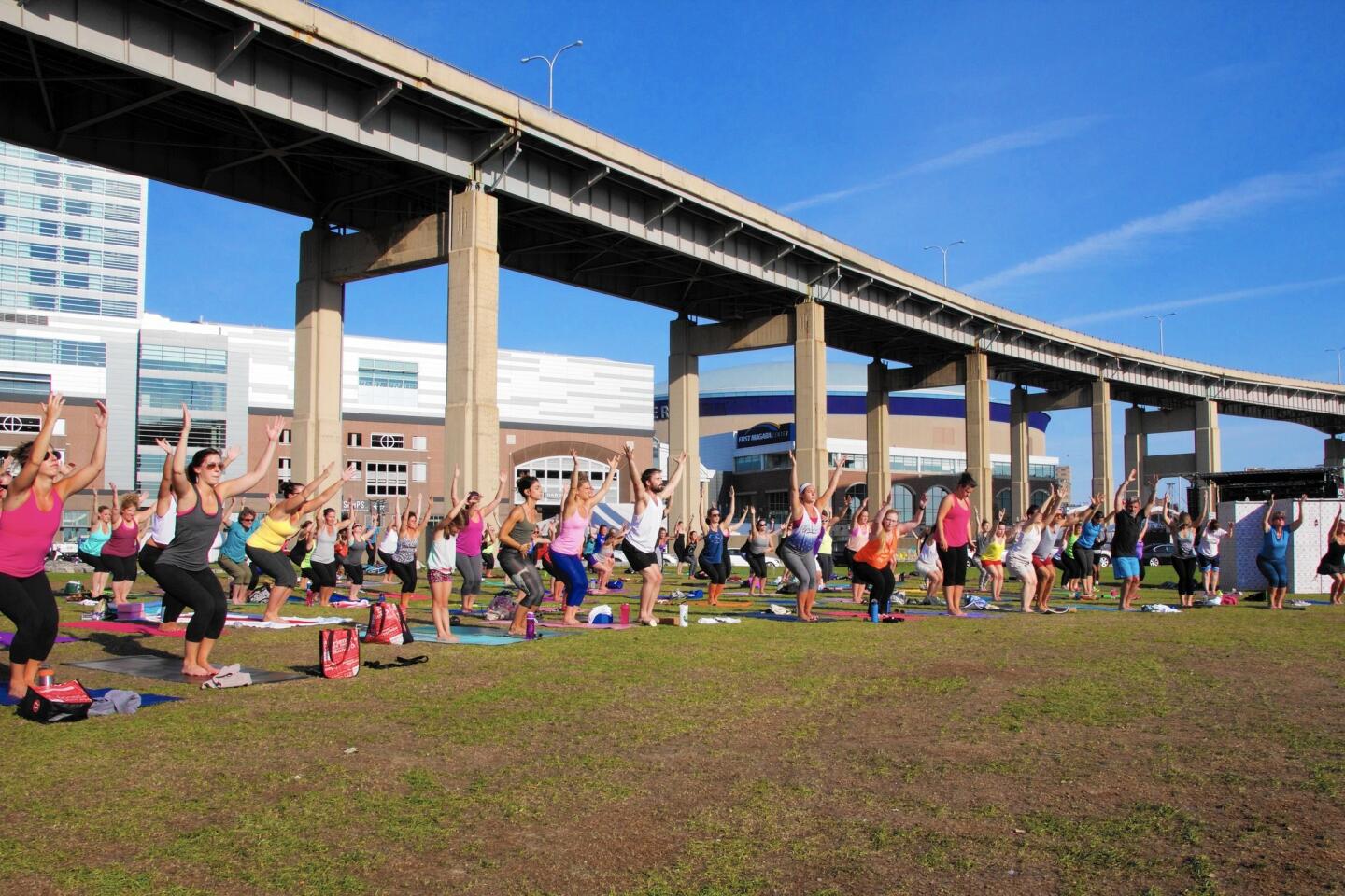 Canalside offers more than just water activities, including this outdoor yoga class under a highway overpass.
