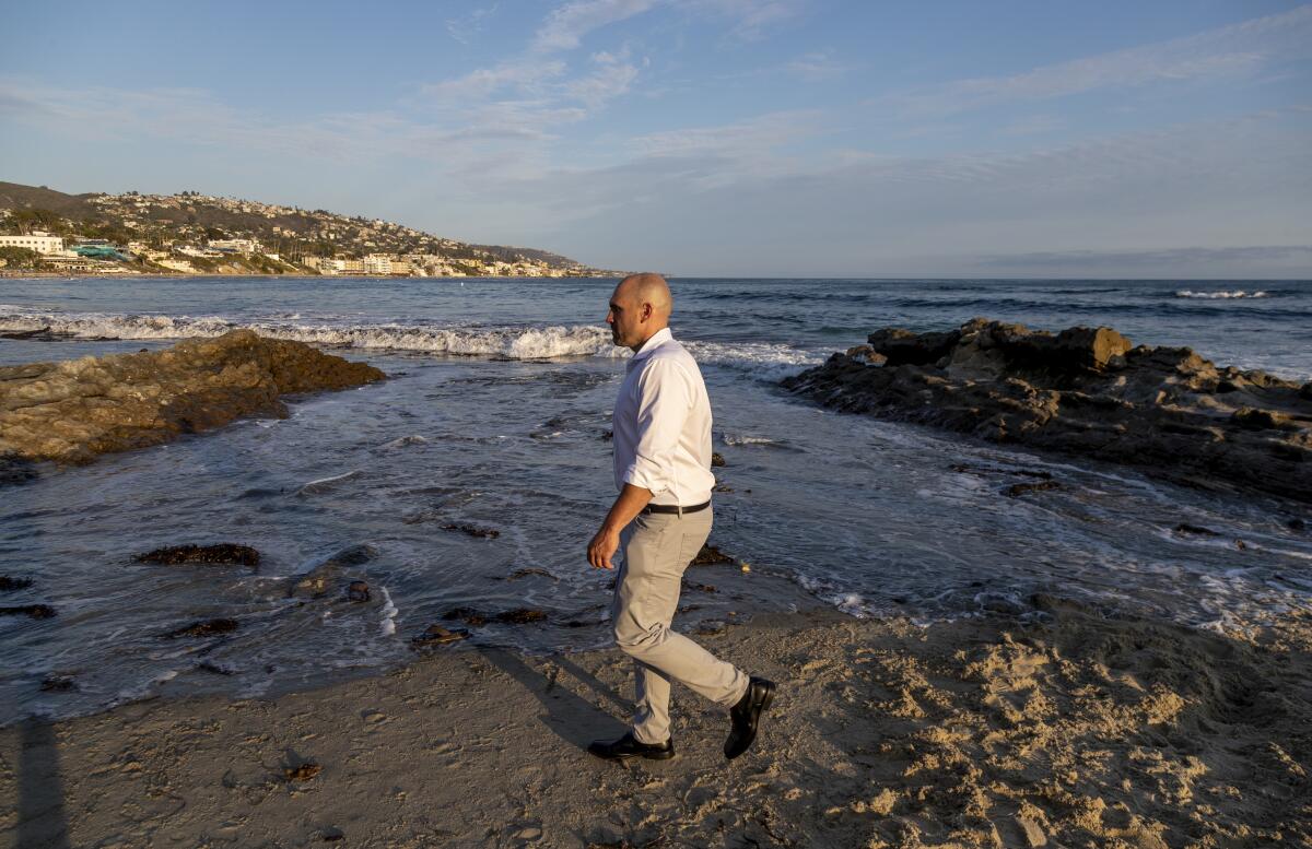 A man walks along the beach