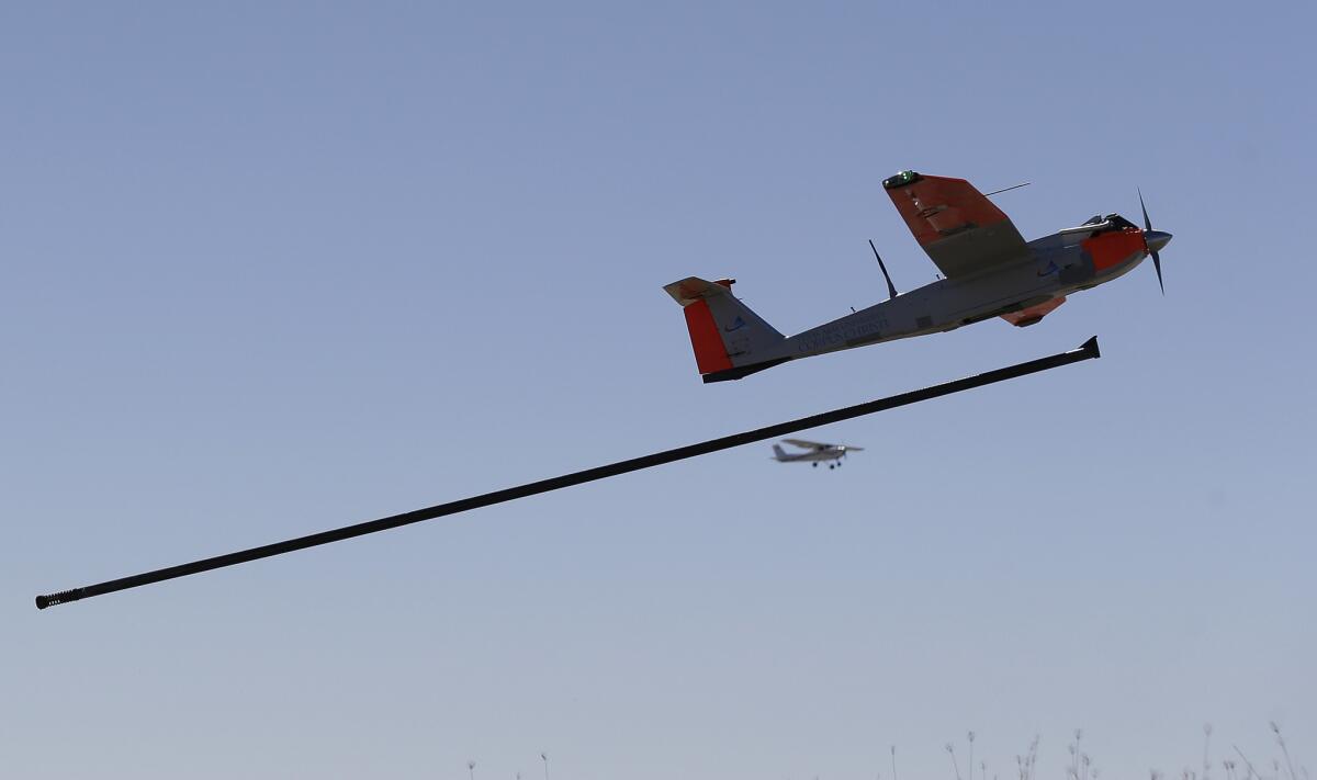A drone is launched by catapult in January in a test as a trail plane follows on a ranch near Sarita, Texas.