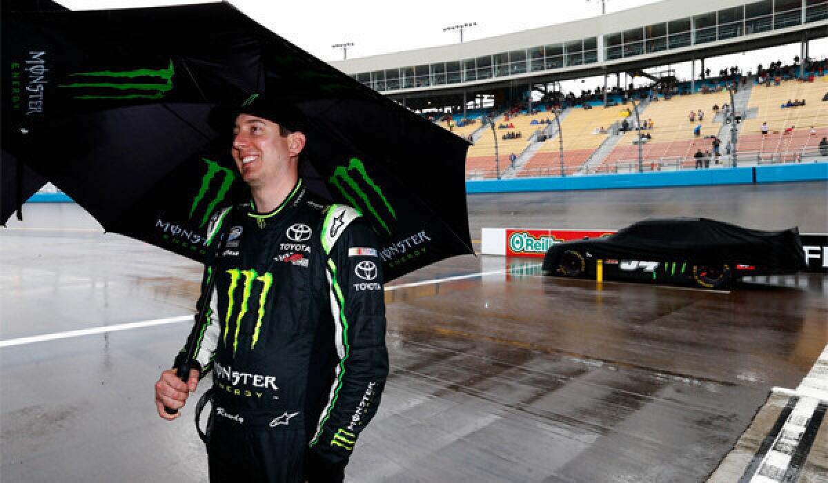Eventual winner Kyle Busch attempts to wait out the rain at the NASCAR Nationwide race at Phoenix International Raceway on Saturday.