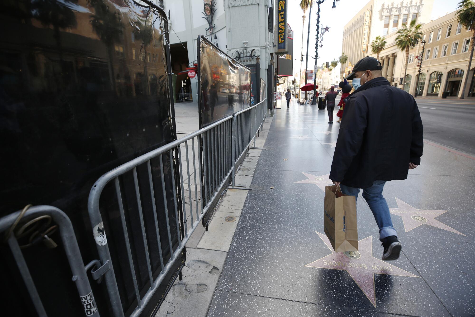 Pedestrians walk past the TCL Chinese Theatre.