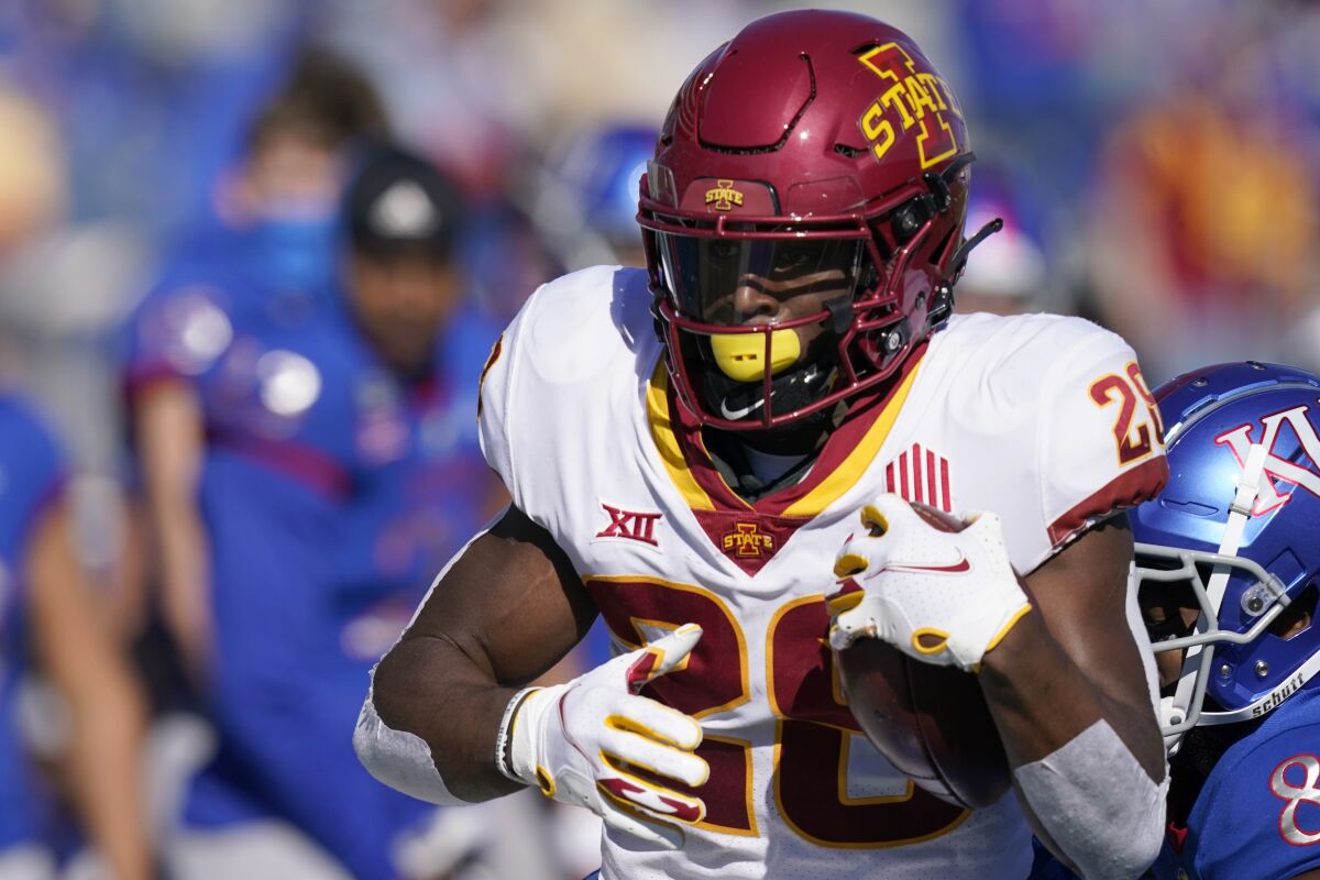 Iowa State running back Breece Hall (28) gets past Kansas cornerback Kyle Mayberry (8) during the first half of an NCAA college football game in Lawrence, Kan., Saturday, Oct. 31, 2020. (AP Photo/Orlin Wagner)