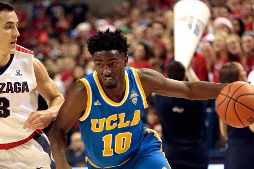 UCLA's Isaac Hamilton drives against Gonzaga's Kyle Dranginis in the first half of the game on Saturday.