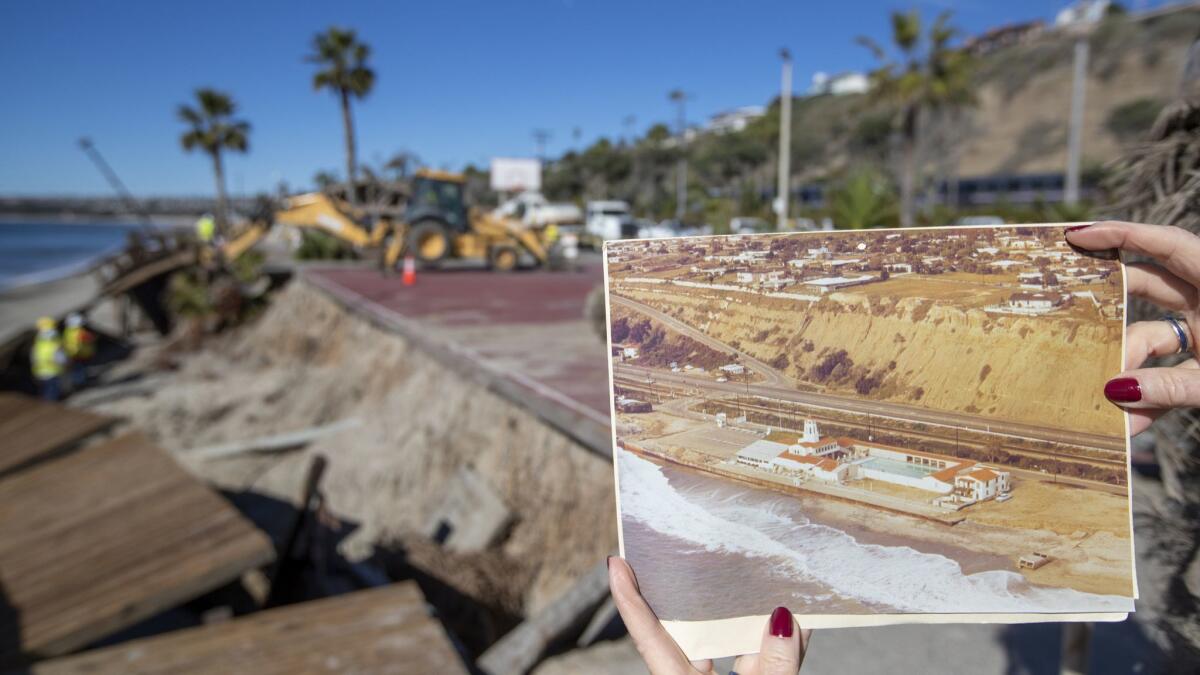 Capistrano Beach resident Sandie Iverson holds a Dana Point Historical Society photo of the old Capistrano Beach Club.