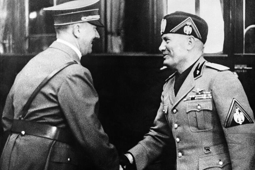 Italian dictator Benito Mussolini after watching the German Army manoeuvres at Mecklenburg, visited the famous Krupp armament factory in company with German Chancellor Adolf Hitler. Adolf Hitler, left, greeting Benito Mussolini on arrival at Essen, in Germany, on Sept. 27, 1937. (A Photo)
