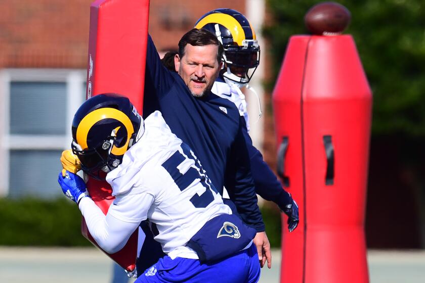 Rams linebacker coach Joe Barry works with Cory Littleton during practice.