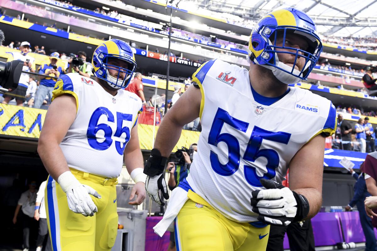 Los Angeles Rams center Brian Allen and center Coleman Shelton run onto the field for warm-ups before Super Bowl LVI.