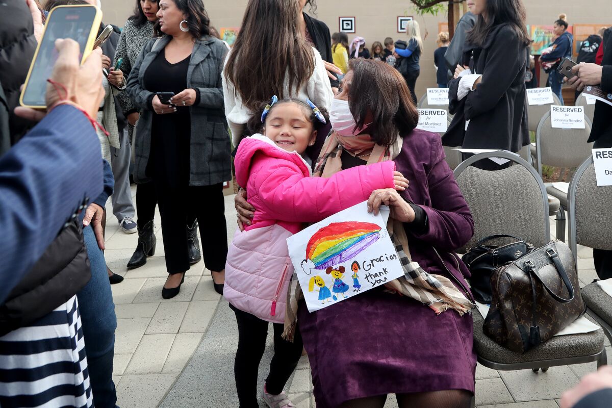 Activist Sylvia Mendez shares a hug with Mia Valencia, 6, of Orangethorpe Elementary School in Fullerton.