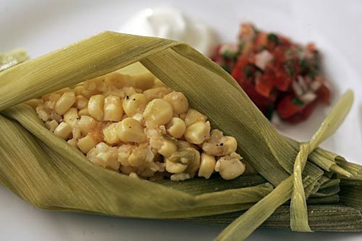 TAMAL: Corn steams up soft and light in fresh husks, with chile and cheese in the mix.