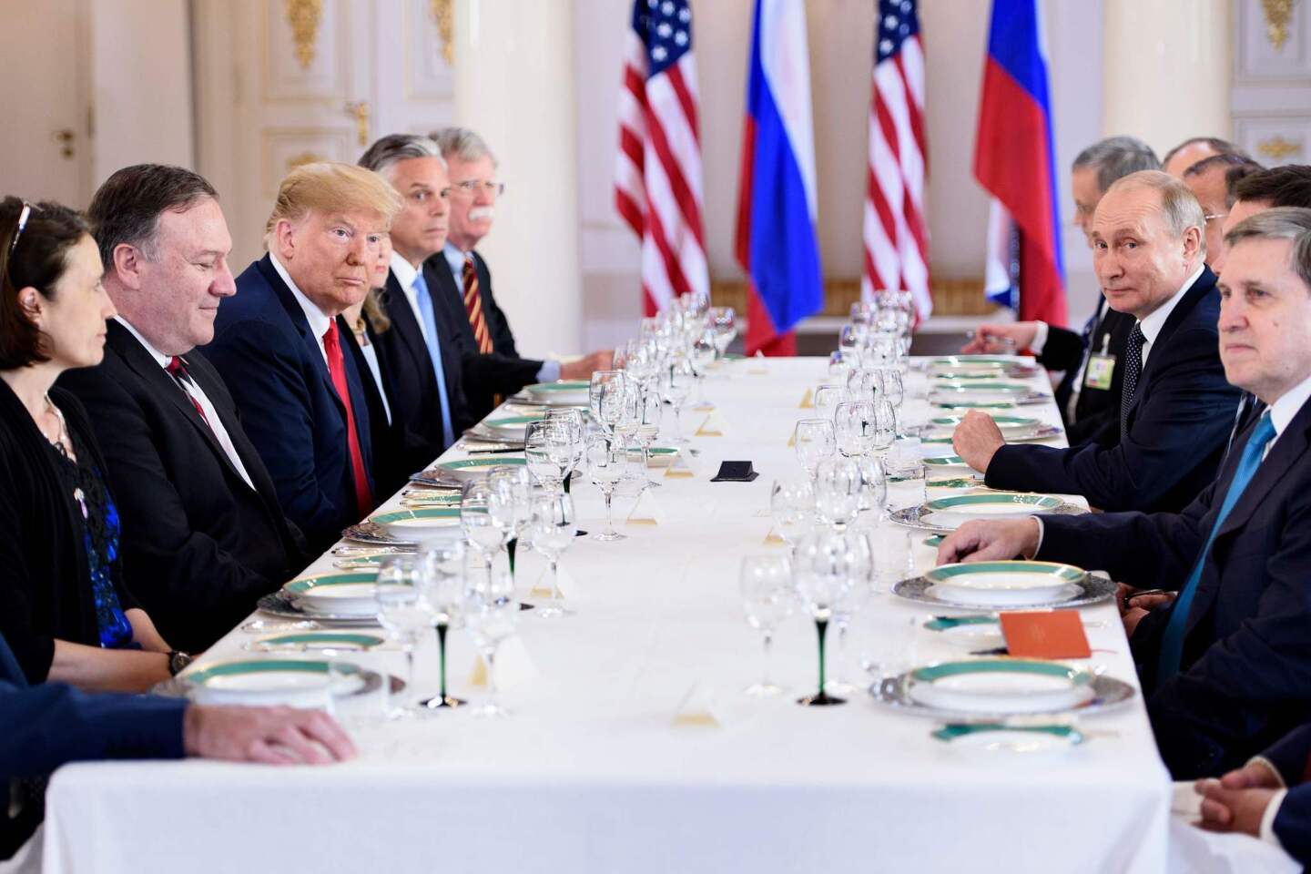 President Trump, center left, and Russia President Vladimir Putin, right, and others wait for a working lunch meeting at Finland's Presidential Palace on July 16 in Helsinki, Finland.