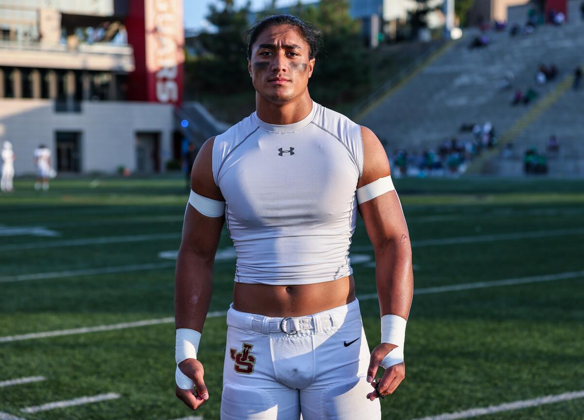 Linebacker Madden Faraimo of JSerra poses for a photo on the football field.