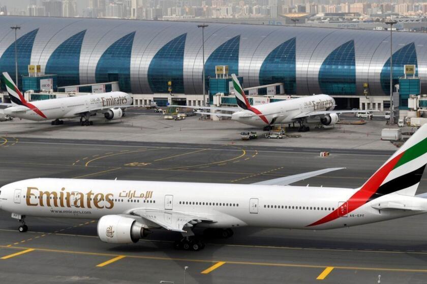 FILE - In this Wednesday, March 22, 2017, file photo, an Emirates plane taxis to a gate at Dubai International Airport in Dubai, United Arab Emirates. Dubai-based Emirates released an ad after video went viral of a United passenger being forcefully removed that toyed with the Chicago-based carrier's longtime slogan. "Fly the friendly skies ... this time for real," it read. (AP Photo/Adam Schreck, File)