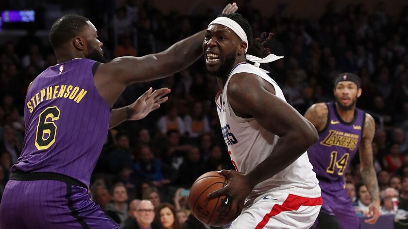Clippers forward Montrezl Harrell is guarded by Lakers guard Lance Stephenson in the fourth quarter Friday.