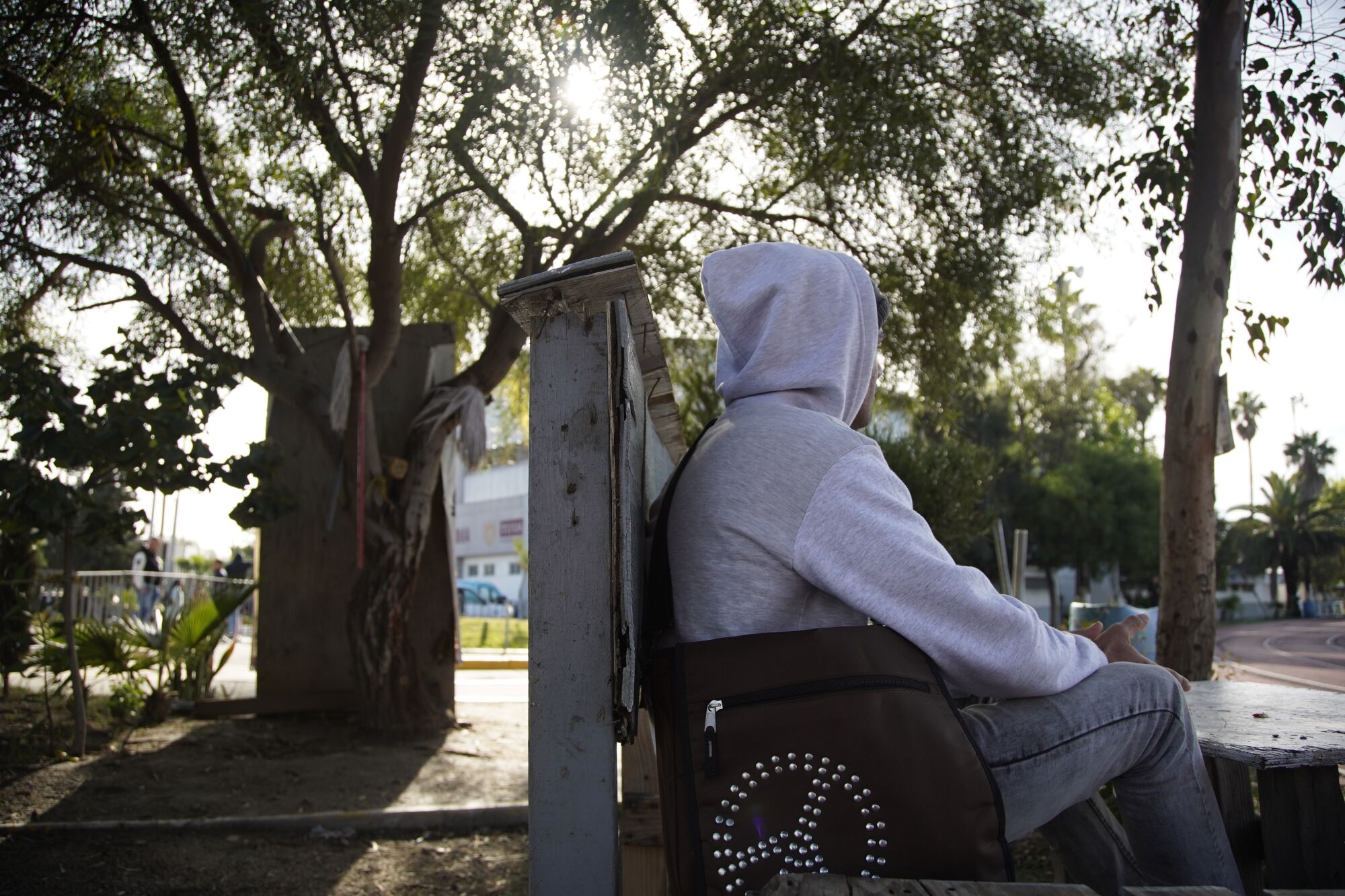 Jesus sits on a bench outside the shelter where he is staying