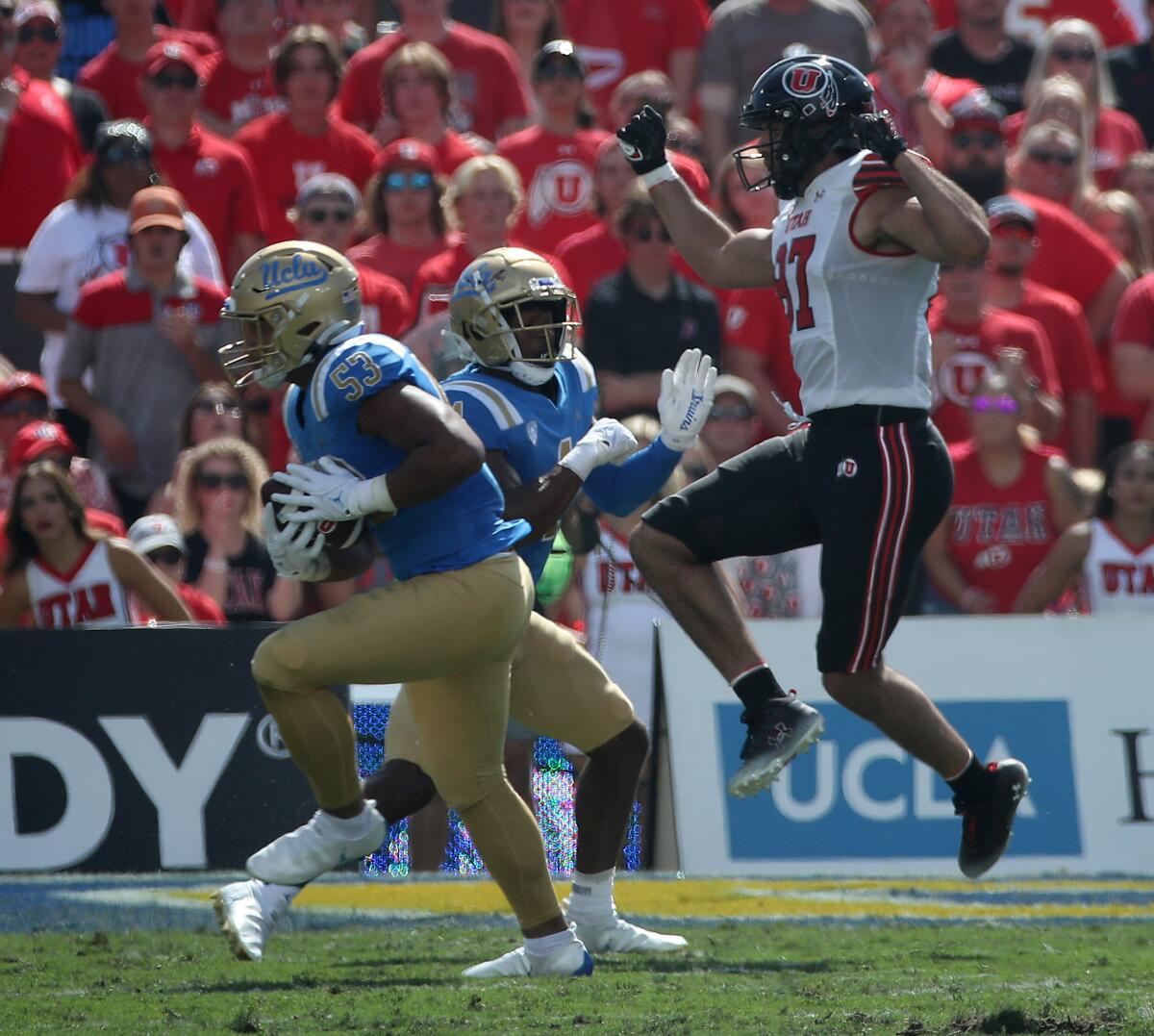 UCLA linebacker Darius Muasau intercepts a pass intended for Utah tight end Thomas Yassmin in the first quarter Oct. 8, 2022.