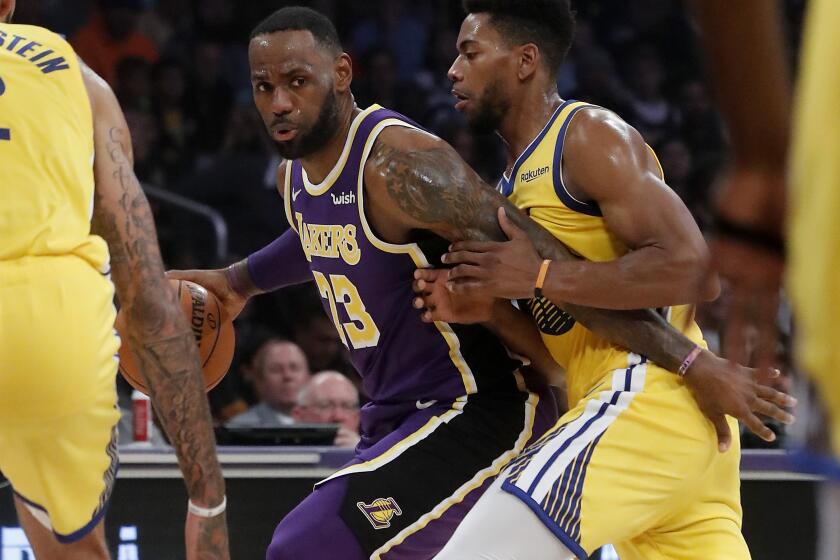 LOS ANGELES, CALIF. - NOV. 13, 2019. Lakers forward LeBron James tries to work the ball inside against Warriors forward Glenn Robinson III in the first quarter at Staples Center in Los Angeles on Wednesday night, Nov. 13, 2019. (Luis Sinco/Los Angeles Times)