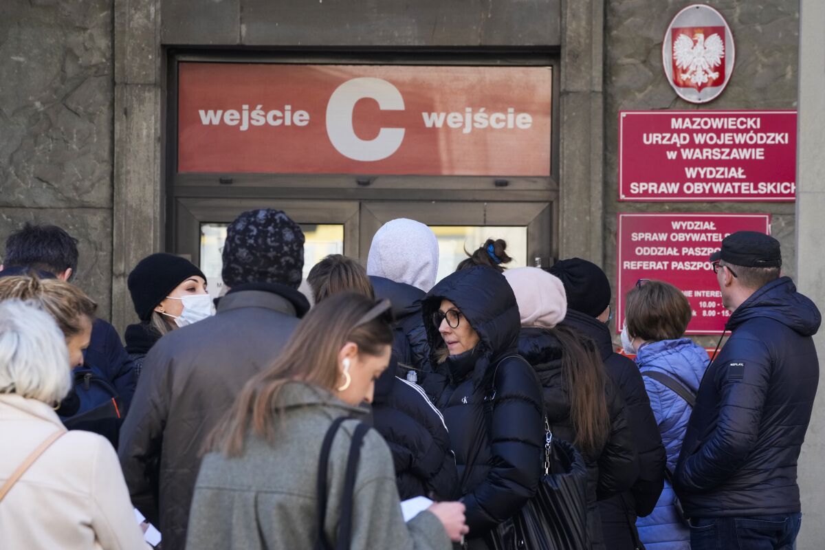 Applicants wait in line at the main passport office in Warsaw, Poland, on Monday, March 14, 2022. Russia's invasion of Poland's neighbor Ukraine has spurred the Poles to take extra measures for their security. On Sunday, a Russian missile strike in western Ukraine, some 15 miles from Poland, killed at least 35 people. (AP Photo/Czarek Sokolowski)