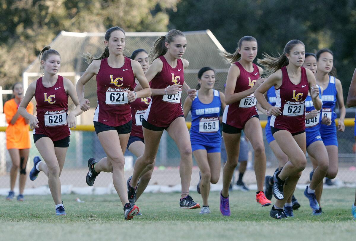 The La Cañada High girls' cross-country team takes off at the start of the Rio Hondo League meet Tuesday at Crescenta Valley Park.