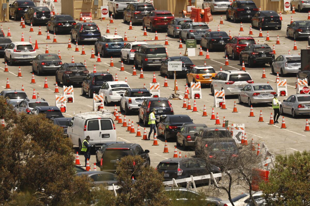 Coronavirus testing continues Wednesday at Dodger Stadium as drivers with an appointment wait in line. 