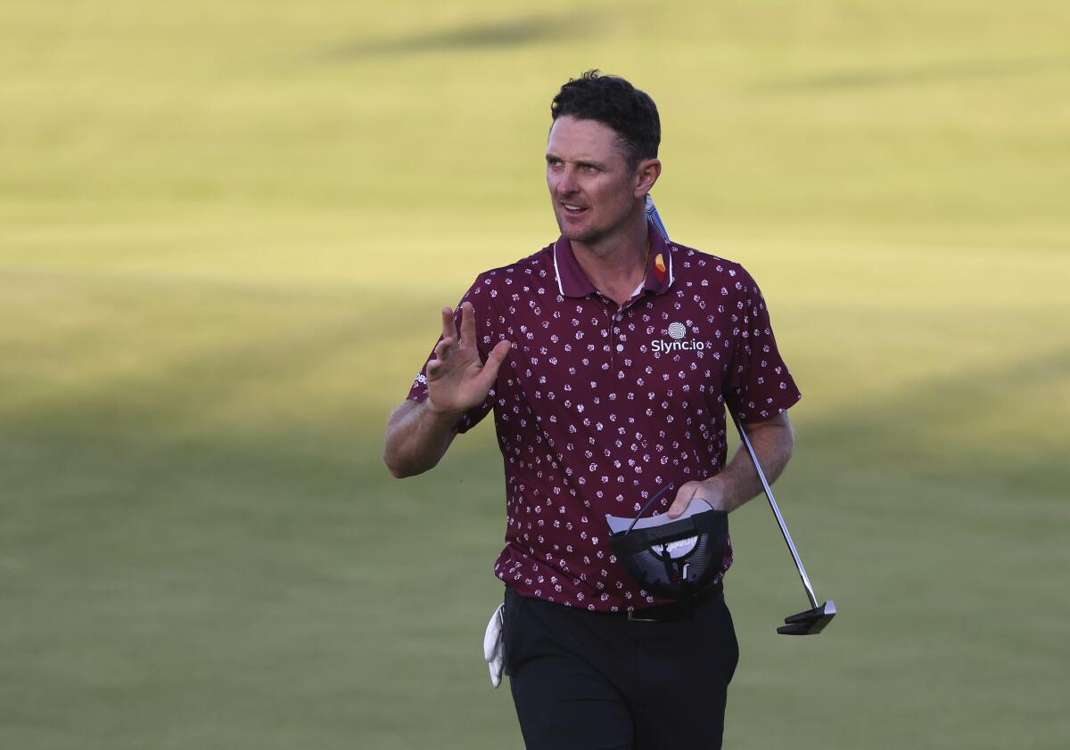 England's Justin Rose gestures to the crowd after putting on the 18th green during the second round of the British Open Golf Championship at Royal St George's golf course Sandwich, England, Friday, July 16, 2021. (AP Photo/Ian Walton)