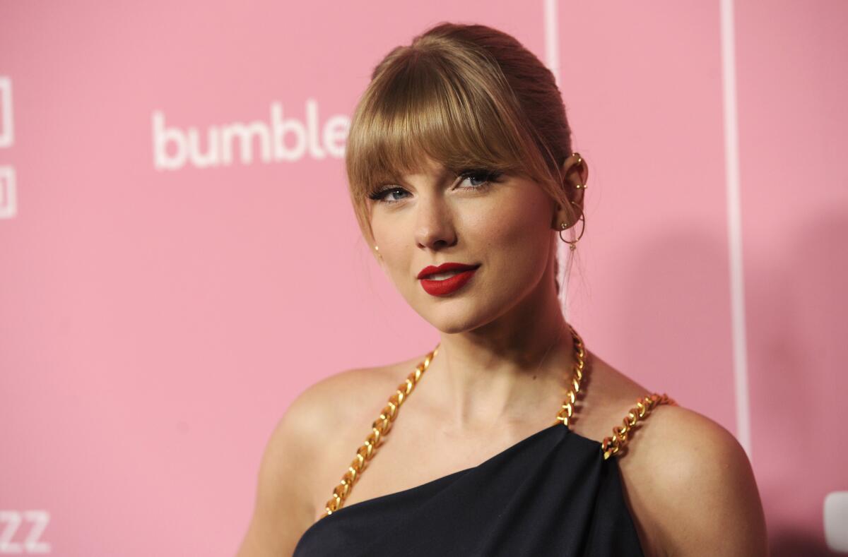 A blond woman with bangs and red lipstick