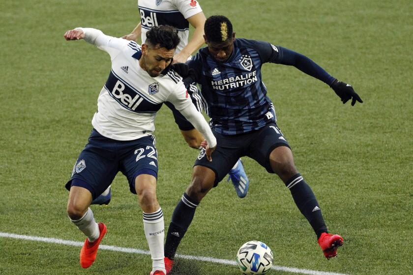 Vancouver Whitecaps defender Erik Godoy, left, and Los Angeles Galaxy midfielder Yony Gonzalez.