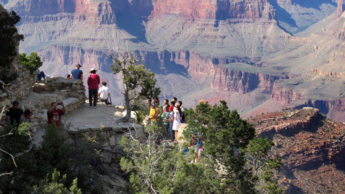 Visitors gather at an outlook on the South Rim of Grand Canyon National Park in northern Arizona on Aug. 19, 2015.