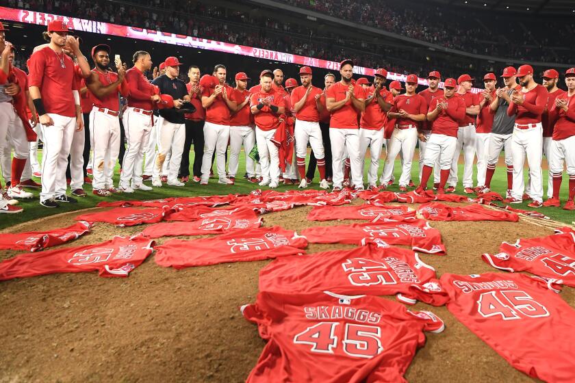 Angel players place their Tyler Skaggs jerseys at the pitchers mound after no-hitting the Mariners.