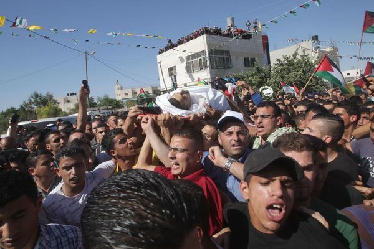 Relatives carry the body of 19-year-old Palestinian Muataz Sharawneh during his funeral in the West Bank town of Dura.