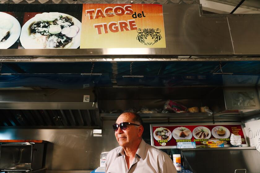 Los Angeles, CA - July 10: Efrain Ayala poses for a portrait at his taco truck Tacos del Tigre on Wednesday, July 10, 2024 in Los Angeles, CA. While not serving customer's, Ayala's truck is parked in the commissary for permitted taqueros as they prepare foods to take to the streets. (Dania Maxwell / Los Angeles Times)