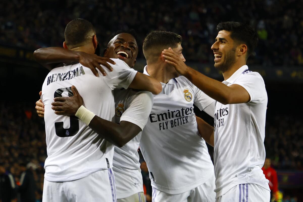 Real Madrid's Karim Benzema, left, celebrates
