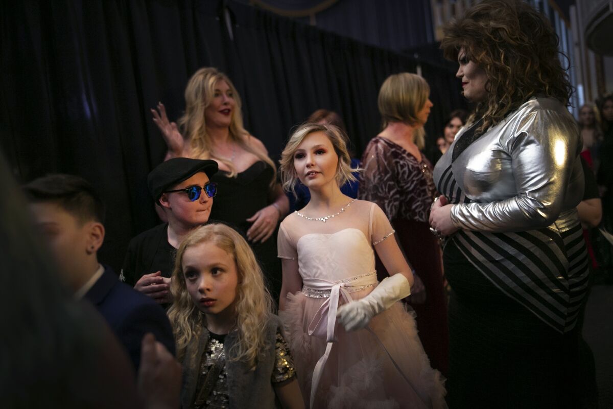Asher, 12, center, waits backstage to walk down the runway with others during a fashion show held by the Trans Club of New England on Friday, Jan. 31, 2020, in Boston. Asher identifies as non-binary and the preferred pronoun is just "Asher." Teachers, staff and students in Asher's school have come to understand: Asher is not a boy, not a girl. Asher is non-binary. Asher is Asher. (AP Photo/Wong Maye-E)