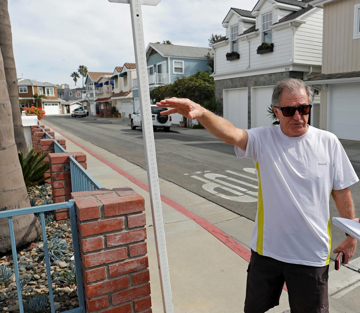 Newport Island resident Gary Cruz points out parking congestion.