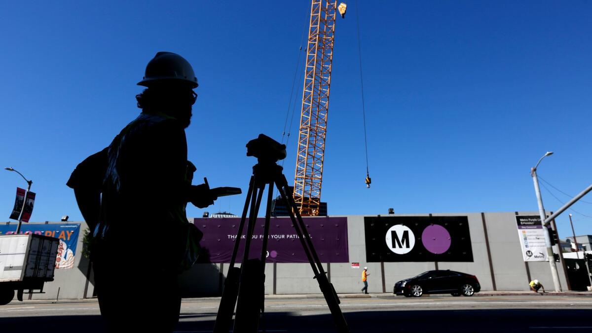 Crews work on the first phase of the Metro Purple Line extension at the corner of Wilshire Boulevard and La Brea Avenue.