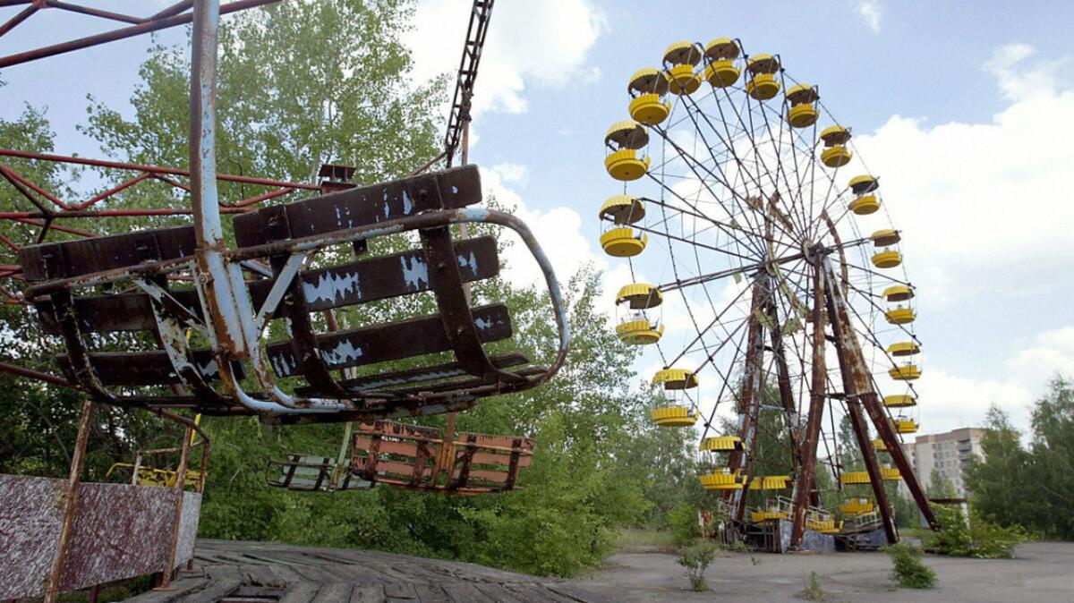 An abandoned Ferris wheel and carousel sit in the amusement park of the Ukrainian ghost town of Pripyat, near the Chernobyl nuclear plant.