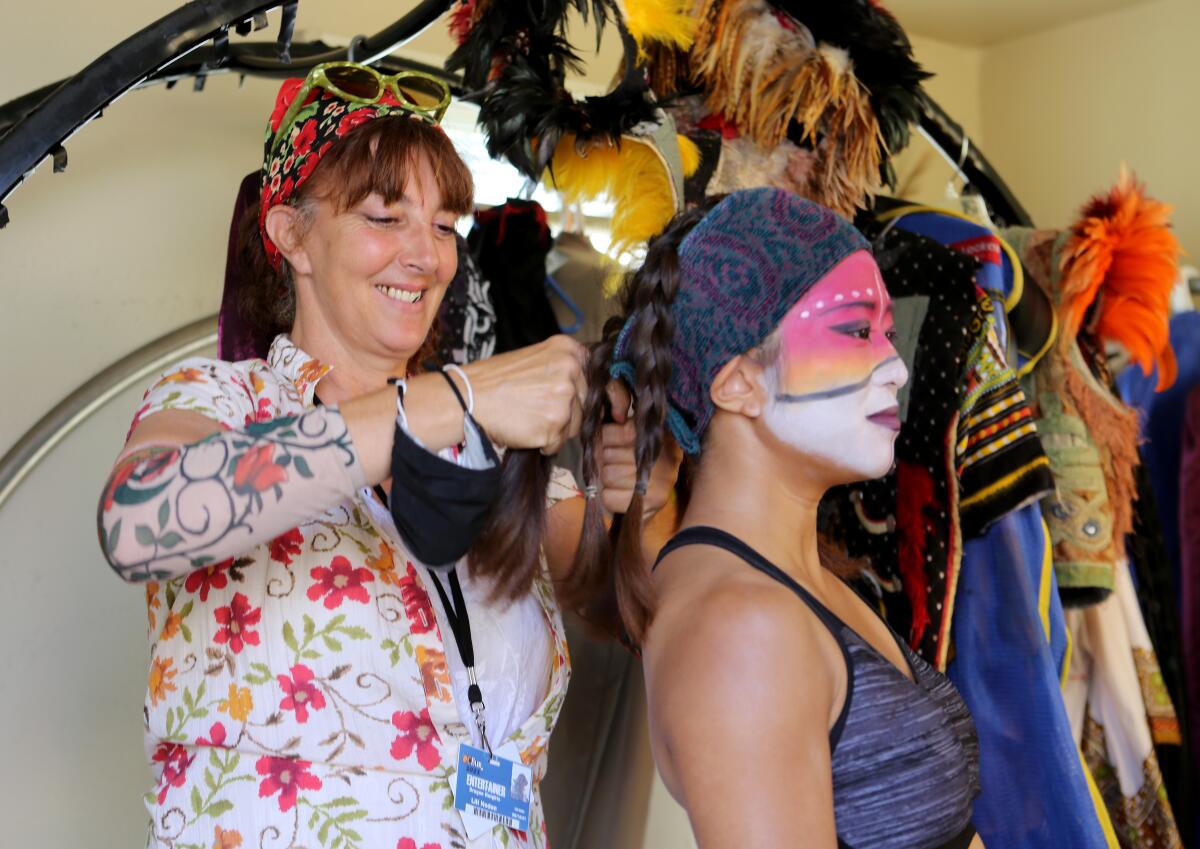 Creator and founder of Dragon Knights Lili Noden helps performer Erena Yoshida, 24 of Irvine, get ready for a performance.