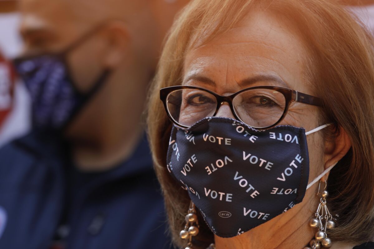 Sen. Maria Elena Durazo (D-Los Angeles) wears a face mask that says "VOTE"