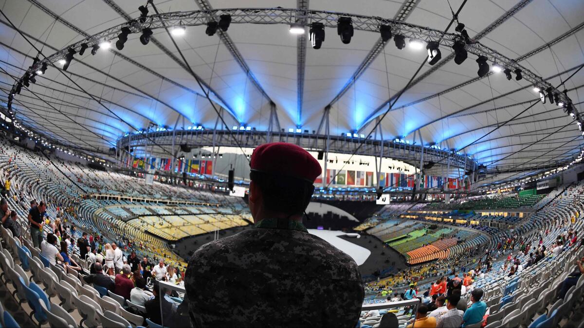 A security guard looks on before the opening ceremony of the Olympic Games at Maracana Stadium in Rio de Janeiro.