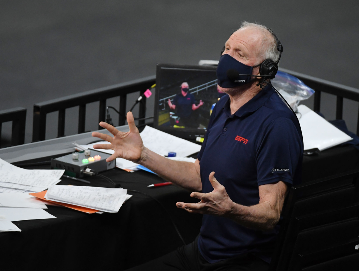Bill Walton wears headphones and comments on a game.