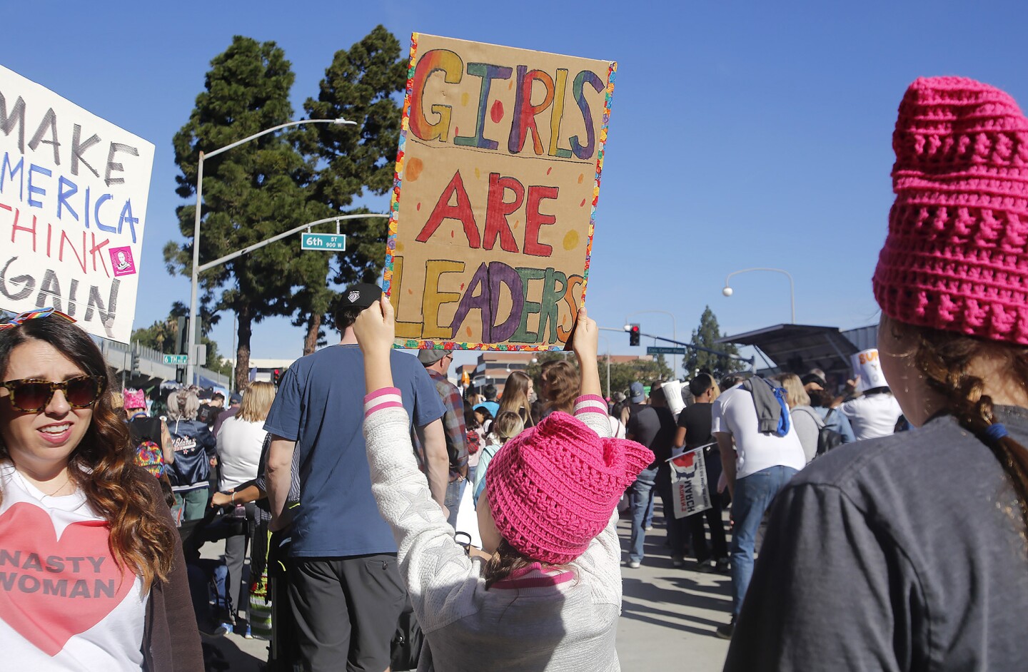 A youngster proudly holds a sign as she joins thousands of others gathered to participate in the Orange County Women's March in downtown Santa Ana on Jan. 19.