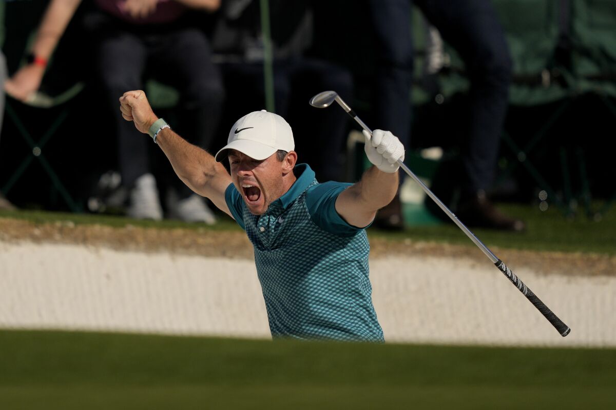 Rory McIlroy reacts after sinking a birdie on a shot out of a bunker on No. 18 at the Masters on Sunday.