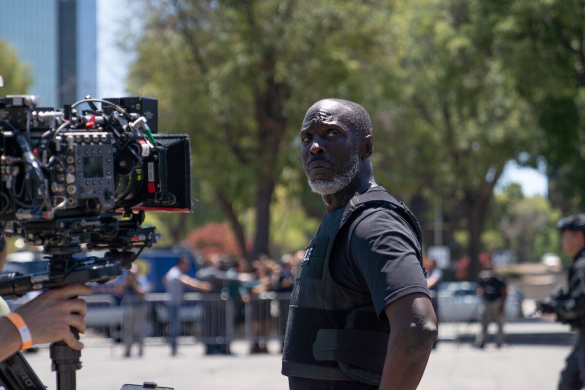 A man stands outdoors looking into a video camera.