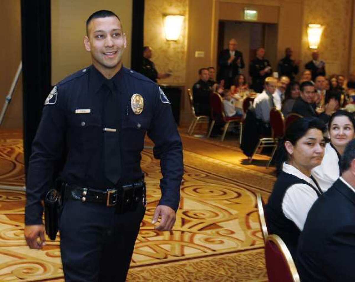 Glendale Officer Jeff Rivas walks to accept the Officer of the Year Award at the 17th Annual Glendale Police Awards Luncheon at the Glendale Hilton.