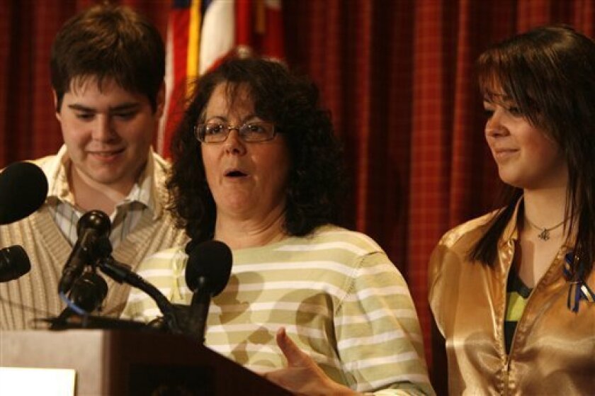 Andrea Phillips, the wife of Capt. Richard Phillips, center, talks during a news conference in South Burlington, Vt., Monday, April 13, 2009. At right is her daughter, Mariah, and at left is her son, Daniel. (AP Photo/Toby Talbot)