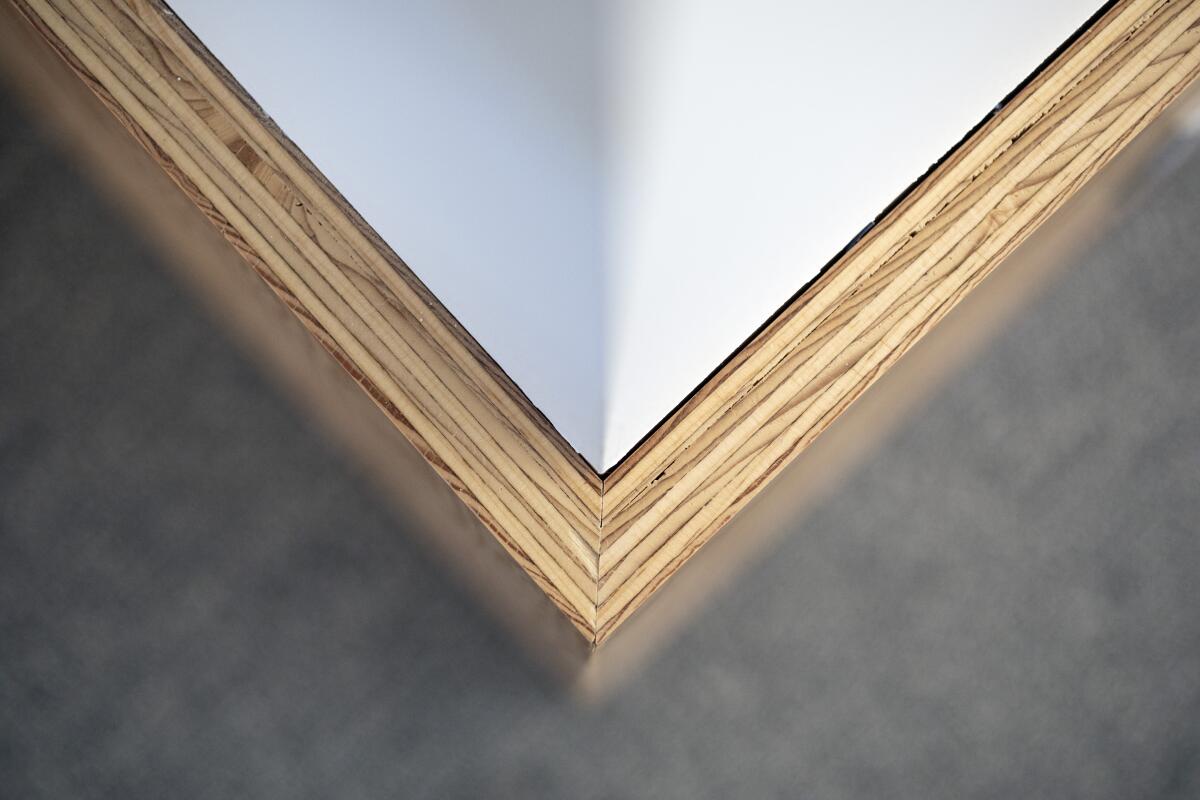 Plywood joinery comes together in the form of an V in an image of an architectural detail