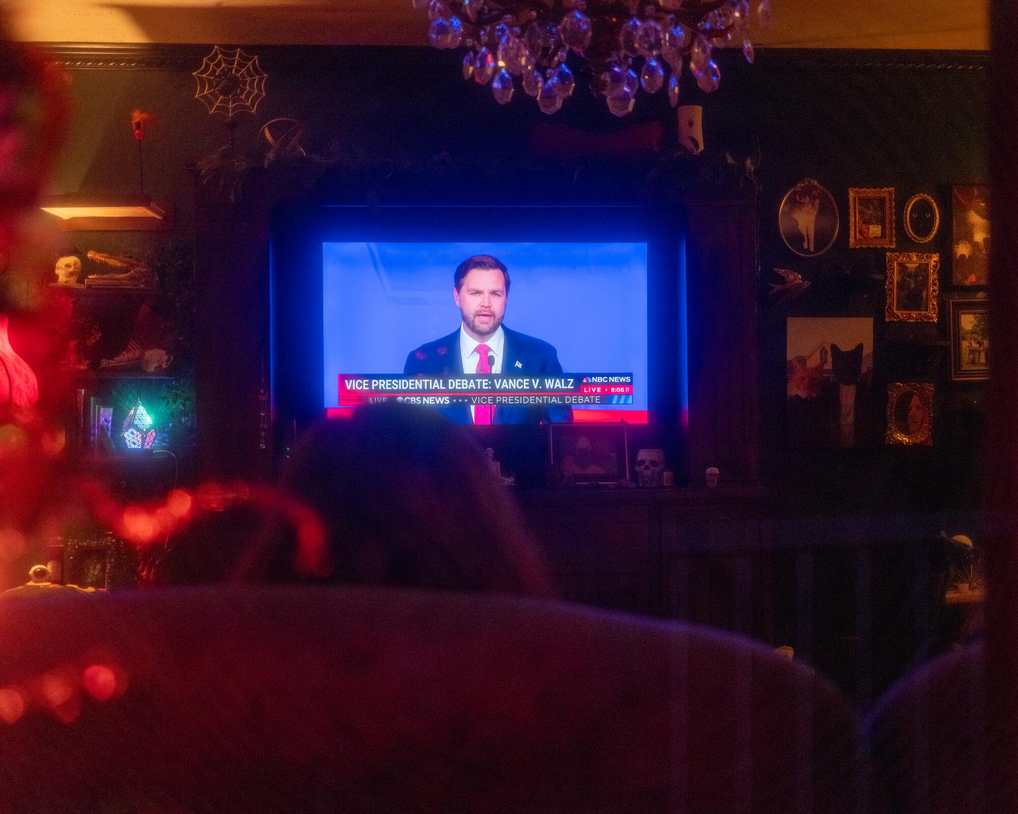 Terra Vance watches the vice presidential debate at her brother and sister-in-law's house in Chauncey, W.Va.