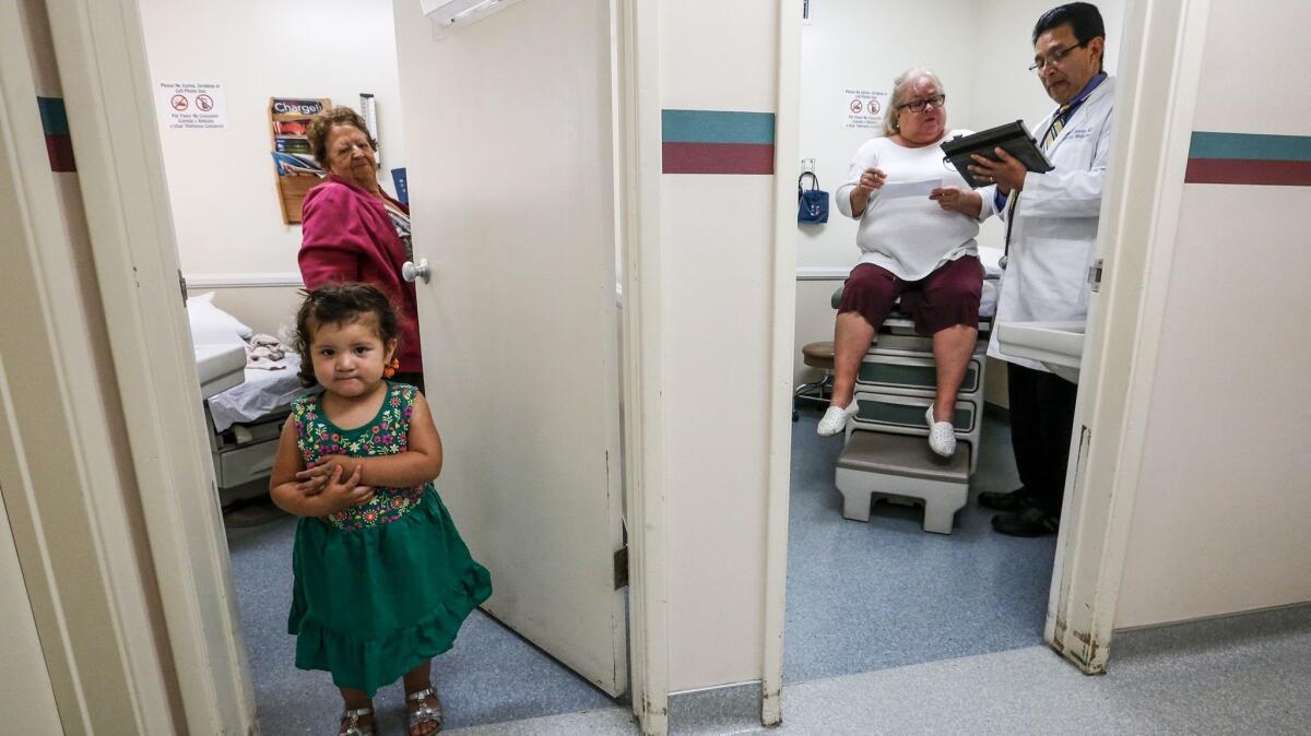 Daniella Gonzales, 2, and her grandmother Maria Gonzales wait for the next appointment while Dr. Juan Montes works with a patient next door in his Whittier office.