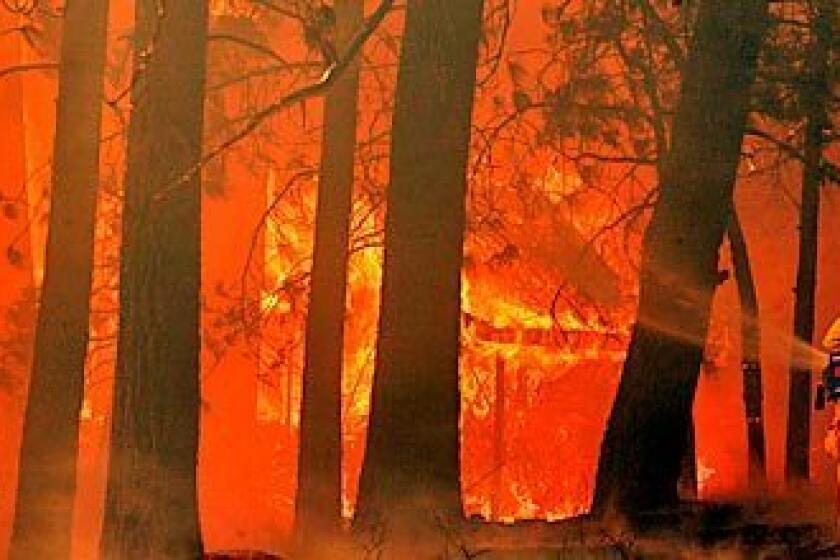 Khan, Irfan -- - Green Valley Lake . October 22, 2007.---- Firefighters fighting fire and gusty winds in Green Valley Lake where three structures are destroyed in fire at 33300 block of Holcomb Creek.