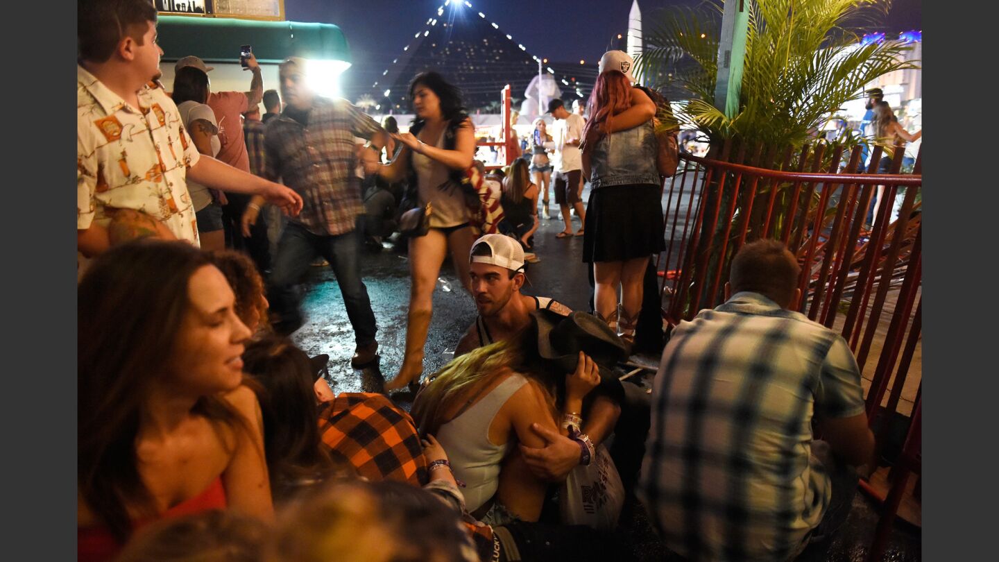 People run for cover at the Route 91 Harvest country music festival after a shooter targeted the event from Mandalay Bay Resort and Casino.
