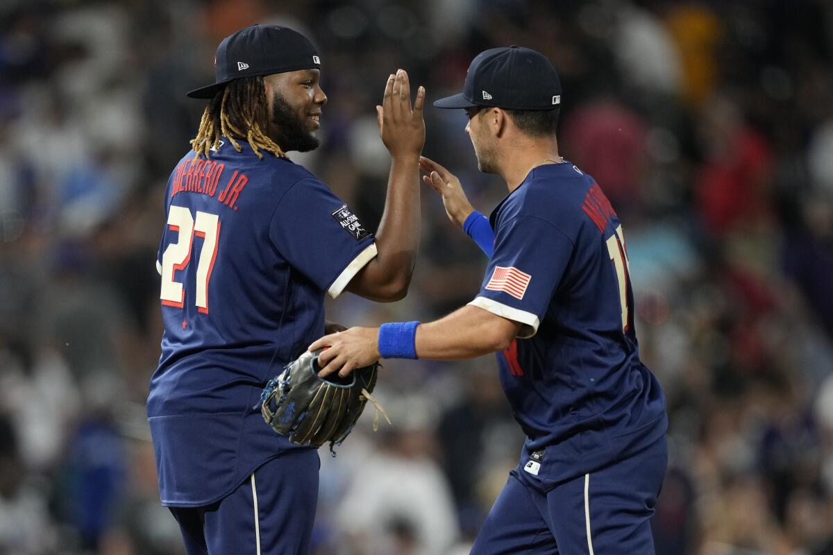 American League's Vladimir Guerrero Jr. greets Whit Merrifield.